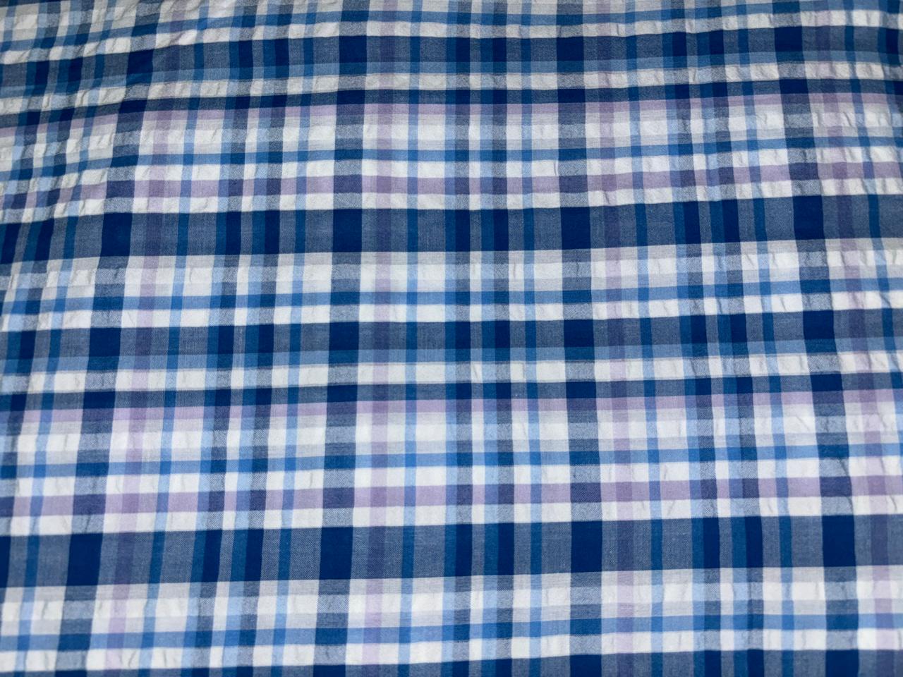 100 % cotton seersucker yarn dyed American plaids  manufactured  by Arvind mills, 58 inches wide /147 cms,available in 2 colors BLUES /PURPLES AND WHITE and  BLUEISH GREY/GREY/PINKS AND WHITE IVORY