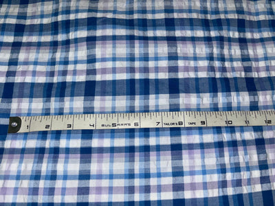 100 % cotton seersucker yarn dyed American plaids  manufactured  by Arvind mills, 58 inches wide /147 cms,available in 2 colors BLUES /PURPLES AND WHITE and  BLUEISH GREY/GREY/PINKS AND WHITE IVORY